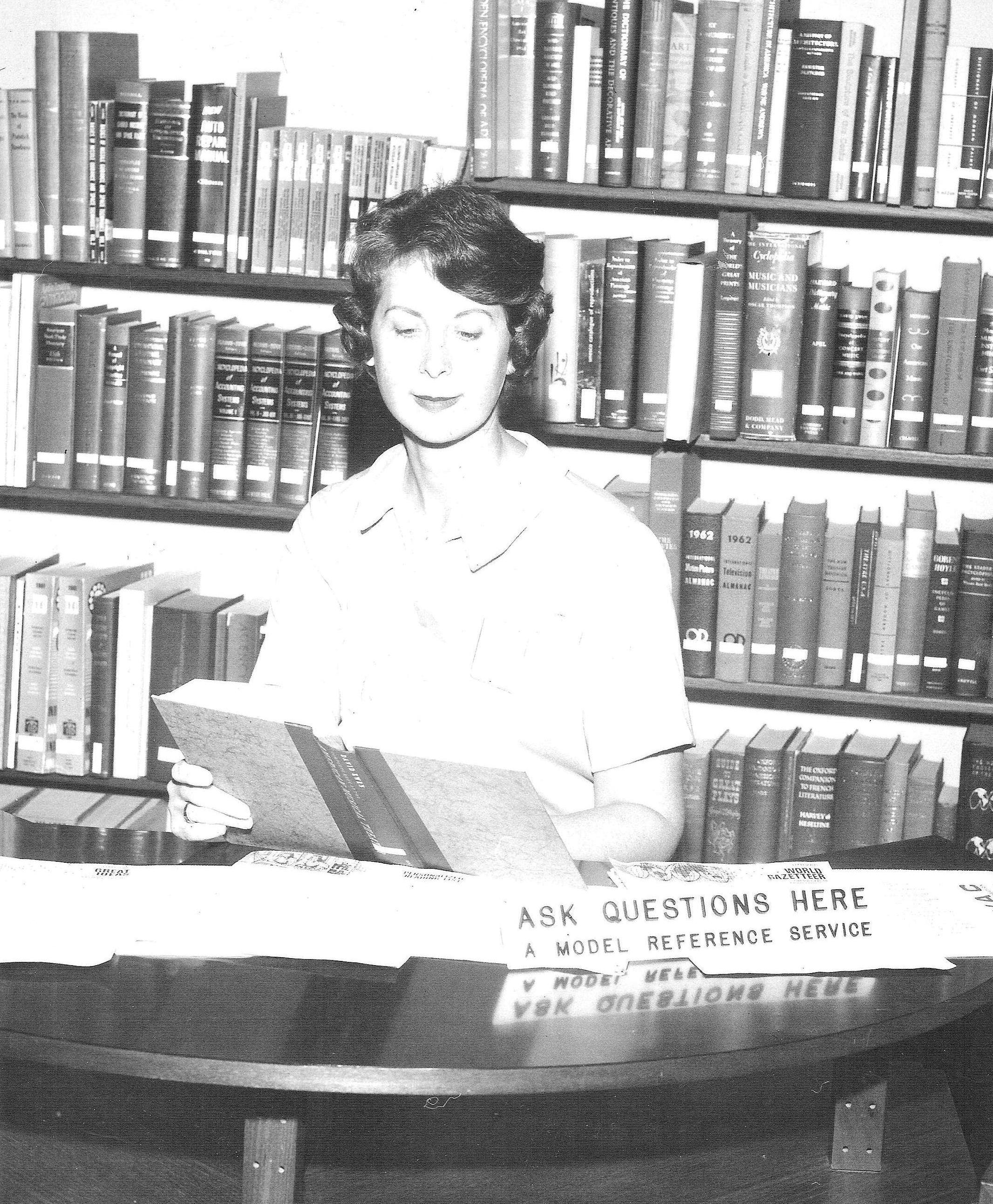 Photo of Dr. Elspeth Pope staffing a model reference desk at the 1962 World's Fair.