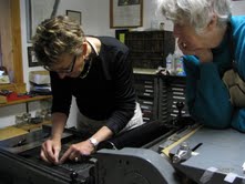 Participants in a 2004 workshop learn to set type.